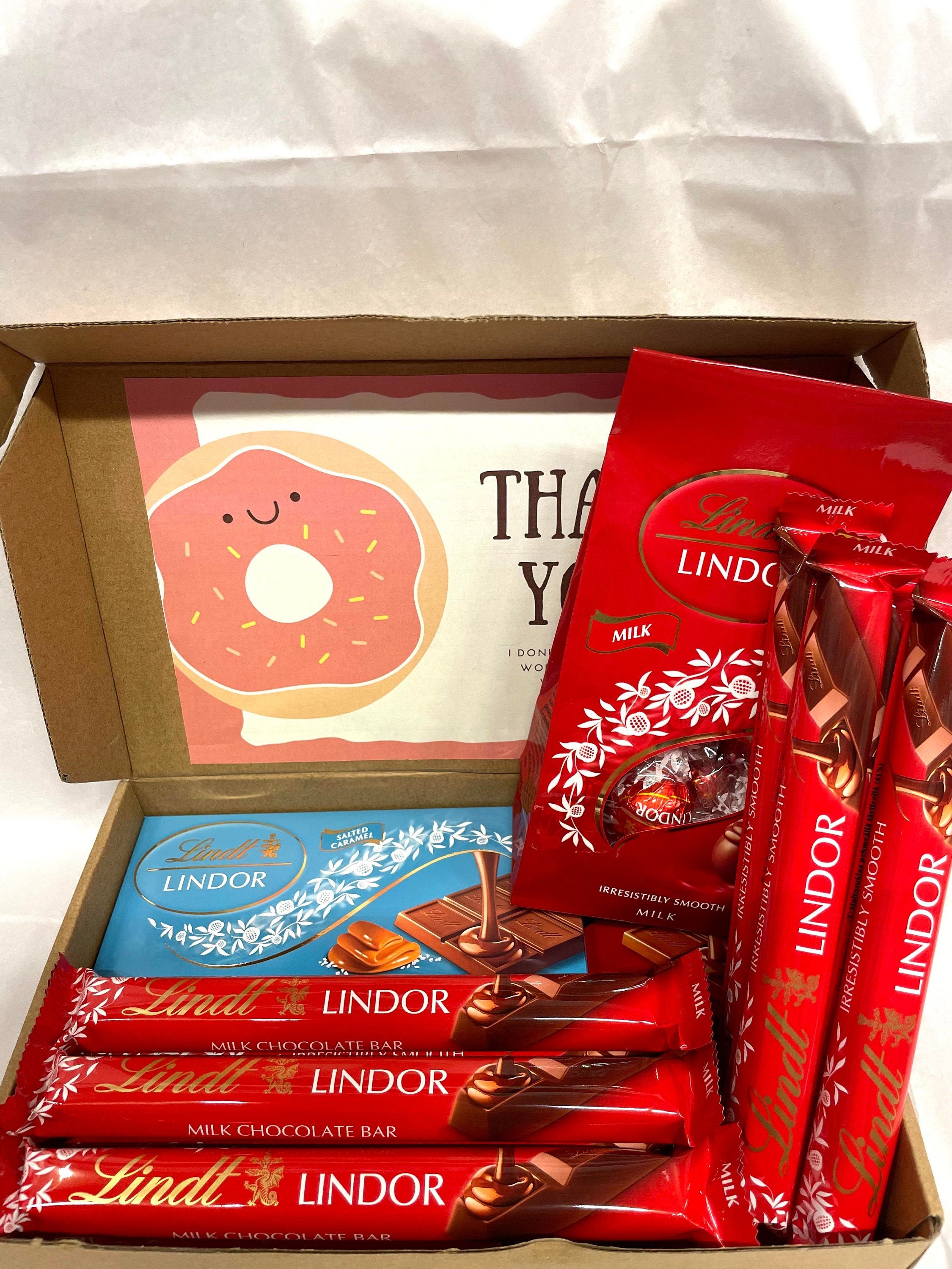 Open Lindt Lindor milk chocolate gift box heavy size with twelve 40g sticks, two 100g bars, one 110g eggs pack and personalized greeting card