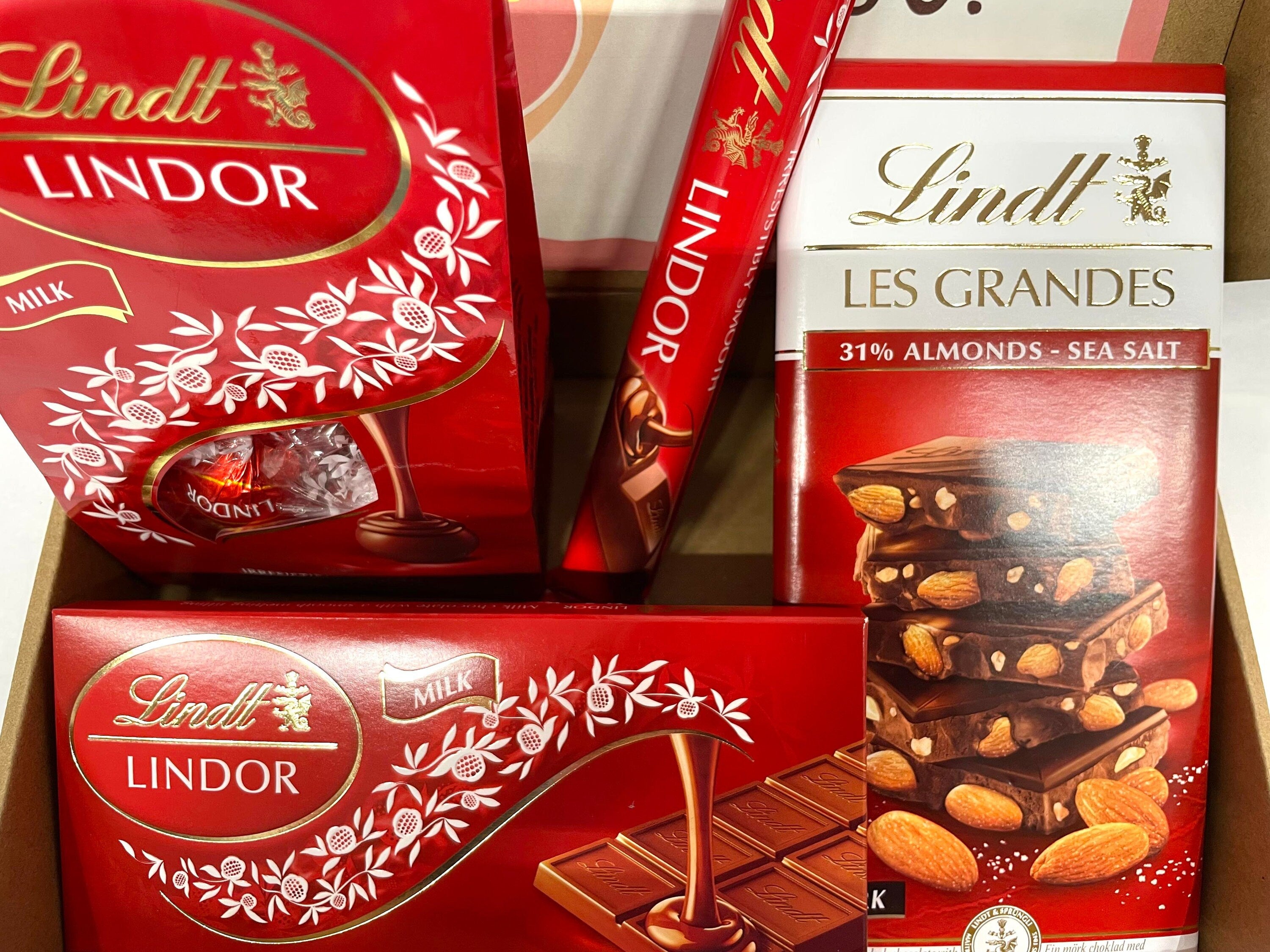 Lindt Lindor milk chocolate gift box medium size containing one 40g stick, one 100g bar, one 150g bar, and one 135g eggs pack