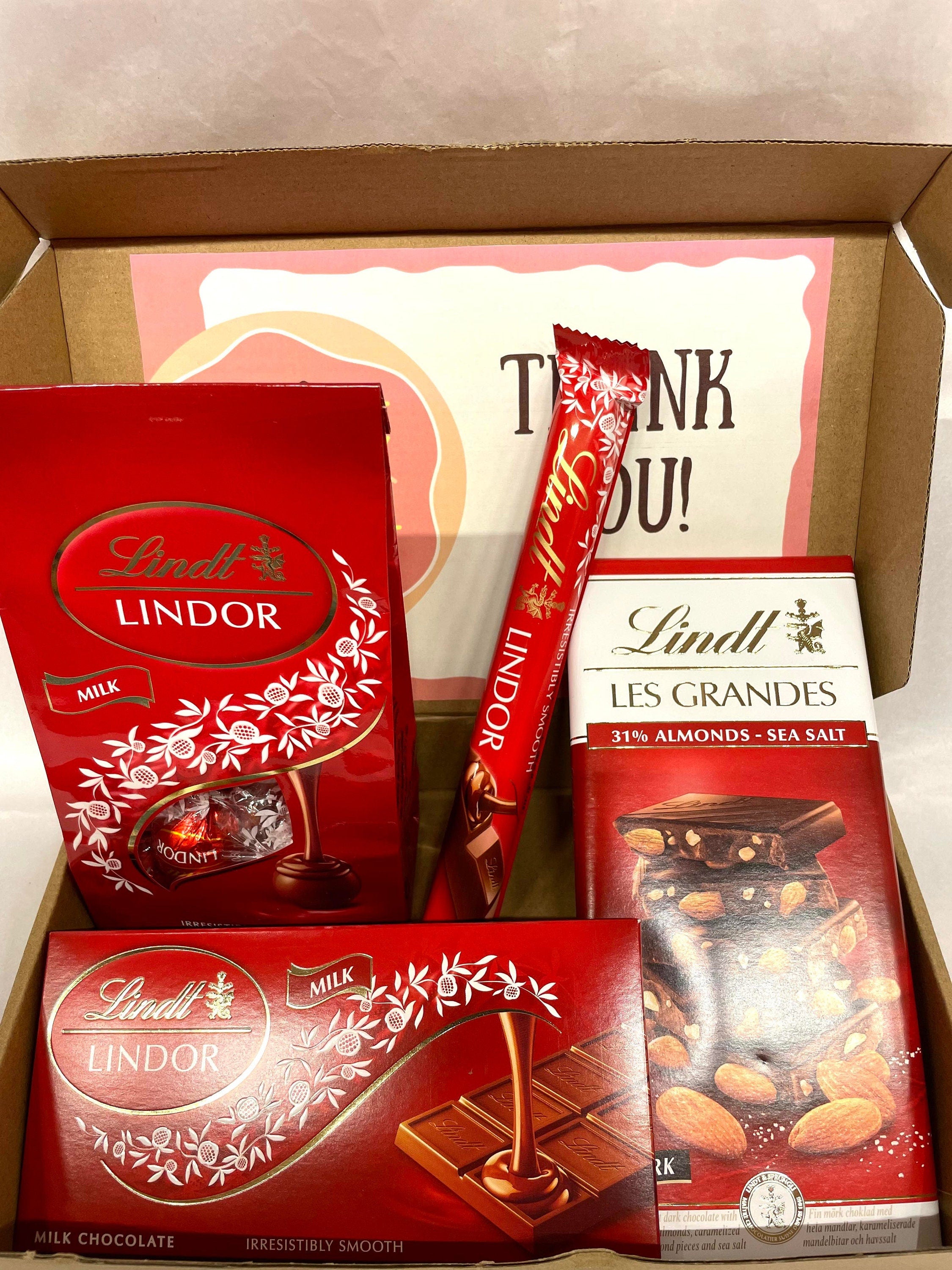 Open Lindt Lindor milk chocolate gift box medium size with one 40g stick, one 100g bar, one 150g bar, one 135g eggs pack and personalized greeting card