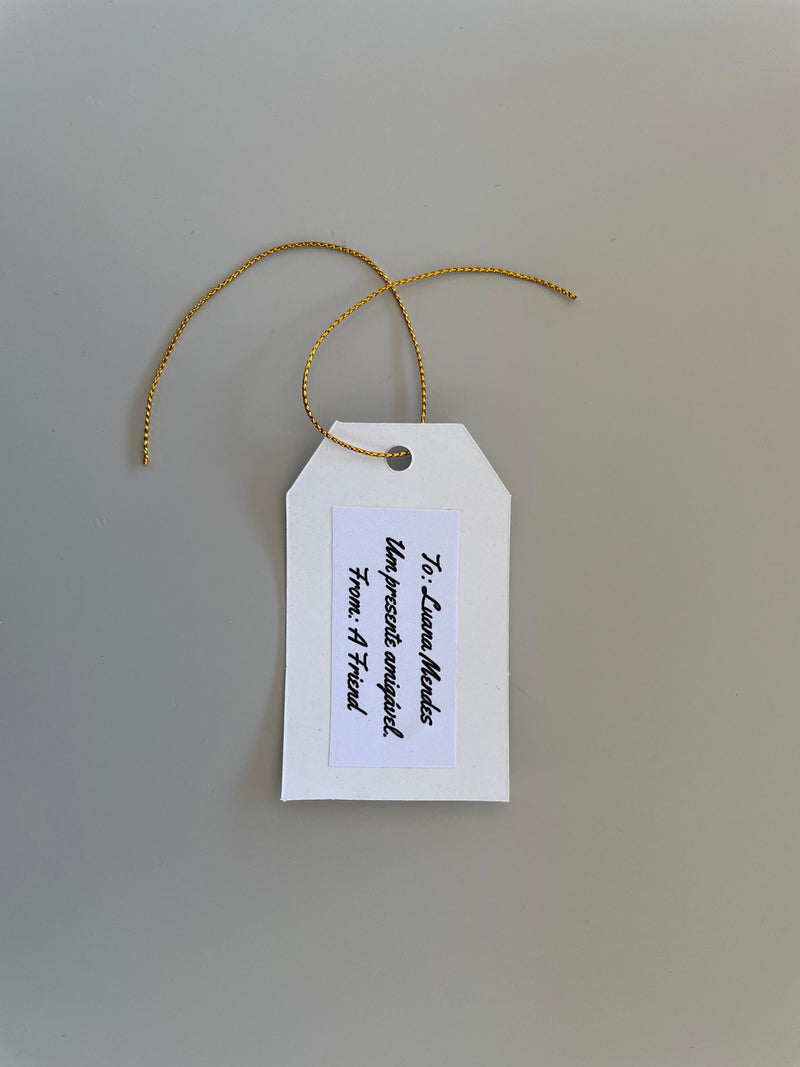 Customizable gift tag showing handwritten personal message with gold cord